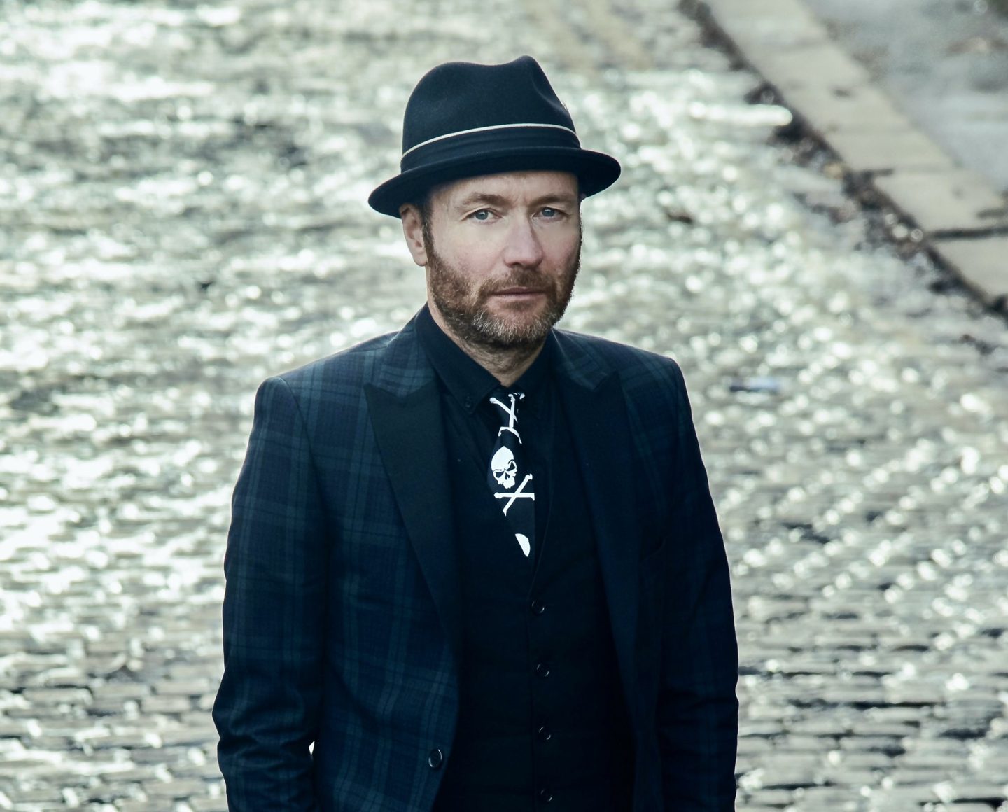Anthony J Brown - stand-up comedian and compere, dressed in a fedora and pinstripe suit